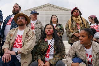 Protesters, including veterans and military families, gather in the Supreme Court for Protest Trump's upcoming military parade in Washington, DC. Friday